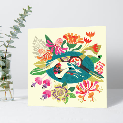 A Flowerbed greeting card by Rollerdog, picturing two sleeping white hounds surrounded by flowers
