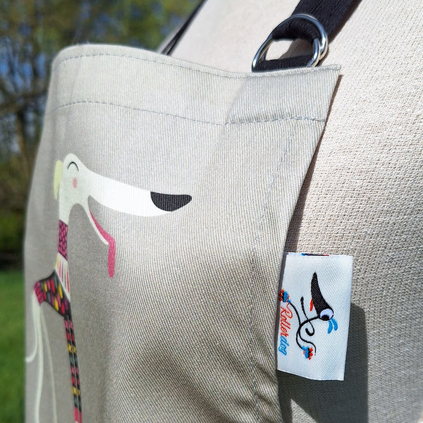 Close up side view of a Graceful Greyhounds apron, showing the adjustable neck halter and Rollerdog tag