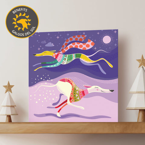 Christmas card featuring two dogs in colourful jumpers on a purple background with 'Benefits Galgos del Sol' logo.