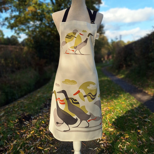 A Derbyshire Ducks apron, shown on a tailor's dummy in a countryside setting