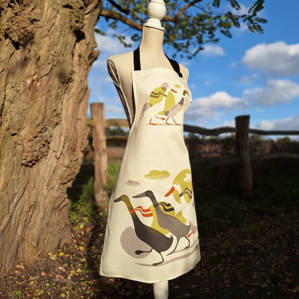 A Derbyshire Ducks apron by Rollerdog, shown on a tailor's dummy in a countryside setting