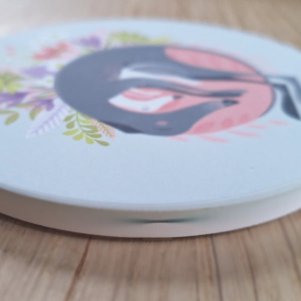 A ceramic Rollerdog ceramic coaster second, showing a print mark on the side of the coaster
