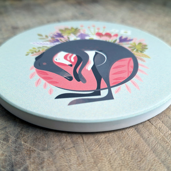 A close-up of a Spring Snuggling coaster showing the print detail and thickness of the coaster.