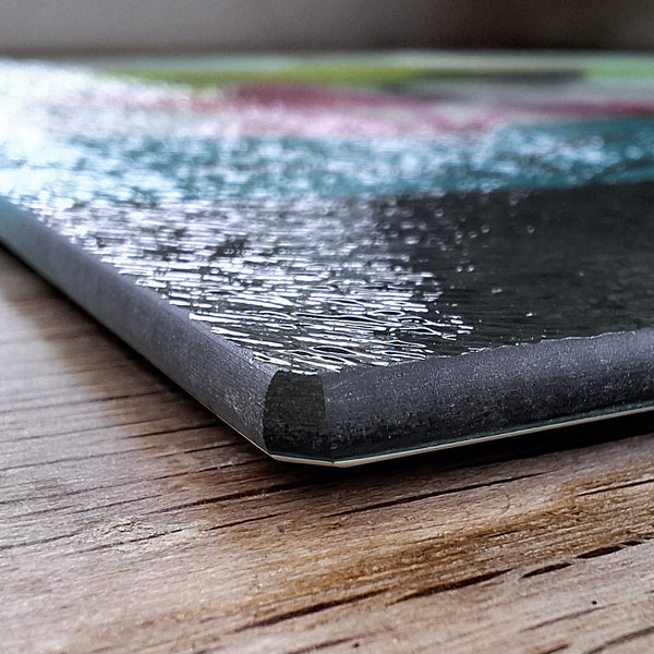 Close up view of the corner of a Rollerdog chopping board, showing the thickness and texture of the board