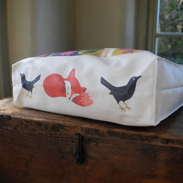 The base of a Dog Rose tote bag, showing the illustrated fox and birds