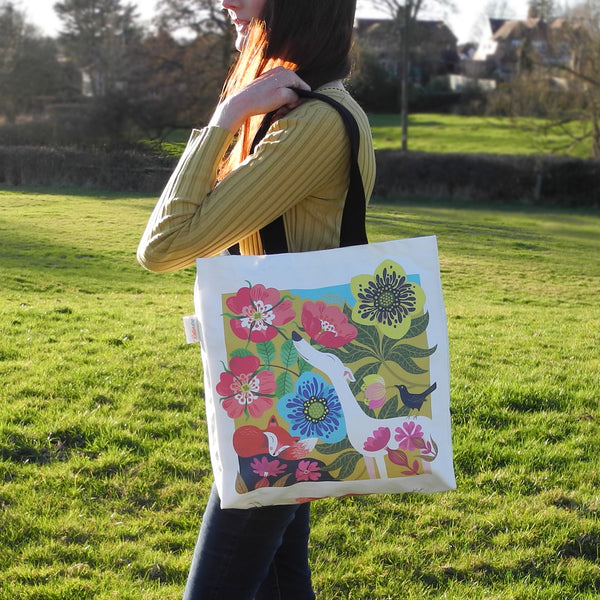 A Dog Rose tote bag by Rollerdog, showing it in use as a shoulder bag
