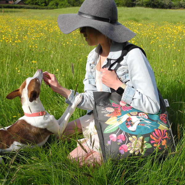 A Flower Bed tote bag in use by a model and her whippet in the countryside