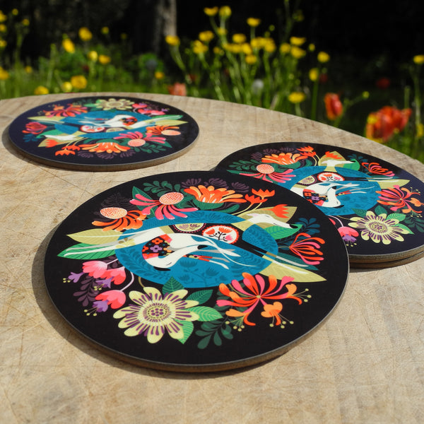 Close up view of a set of Rollerdog flower Bed coasters, photographed outside amongst flowers