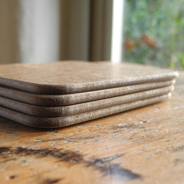 A stack of Rollerdog coasters, showing the underside