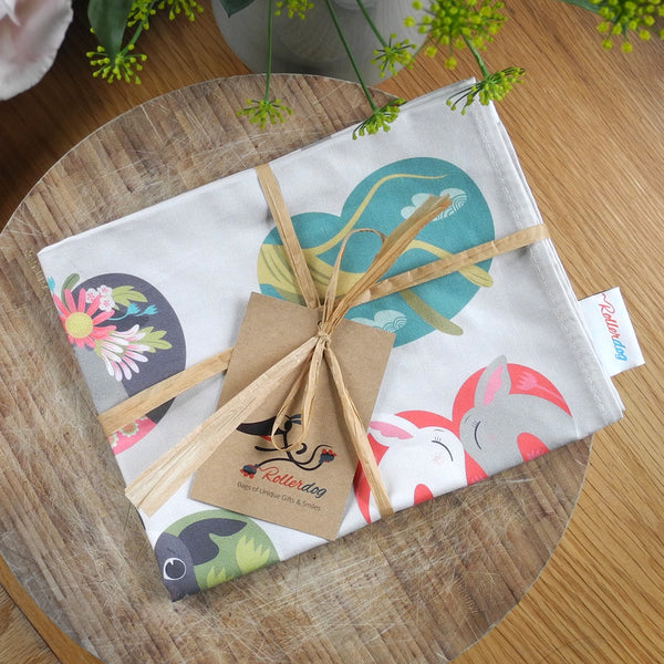 Noses & Poses tea towel with gift ribbon and Rollerdog tag