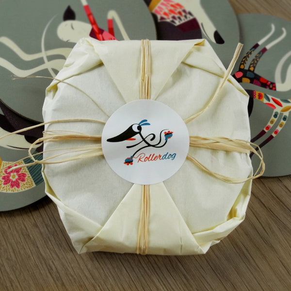 A set of Rollerdog coasters wrapped in tissue paper and raffia