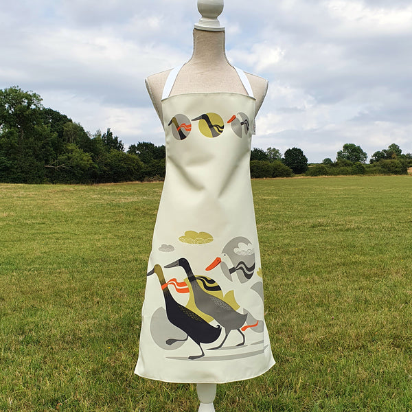 A rollerdog apron featuring the Three Ducks from Derbyshire design, photographed in the countryside