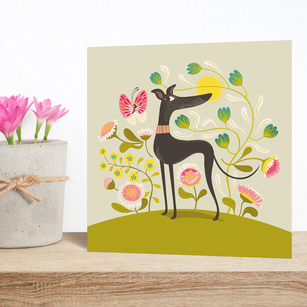 Freddie the Tripod greeting card by Rollerdog, picturing a three legged greyhound on a background of flowers