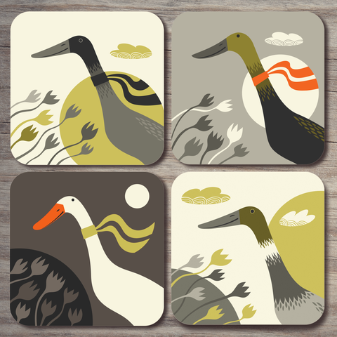 The full set of 4 Indian runner duck coasters by Rollerdog, shot from above on a wooden surface