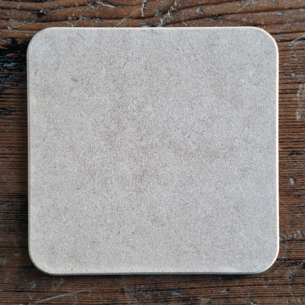 The back of a wooden duck coaster