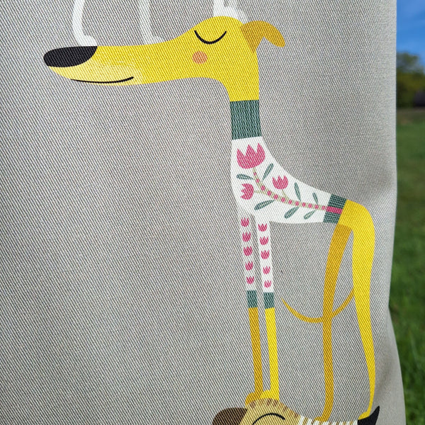 One of the dogs in the Graceful Greyhounds design on a Rollerdog apron