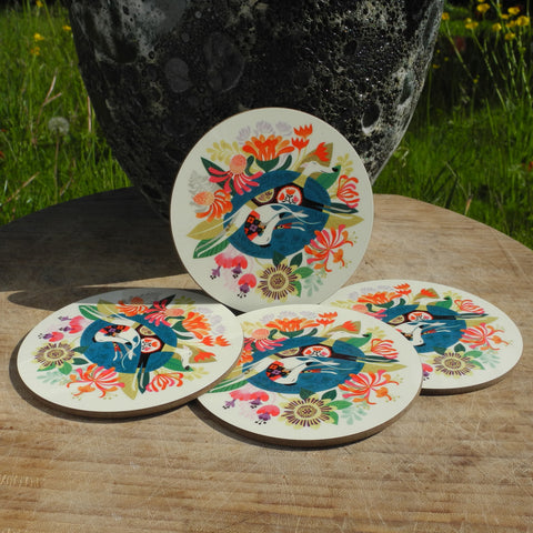 A set of 4 Rollerdog Flowerbed coasters, photographed outside