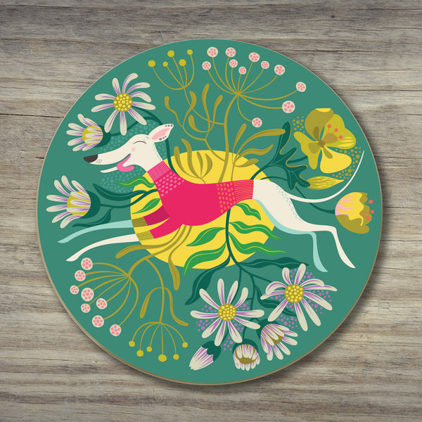 Snowy the Whippet coaster by Rollerdog, showing an illustrated whippet bounding through a flowery teal landscape