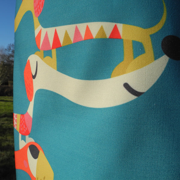 Detail of Dashing Dachshunds apron by Rollerdog