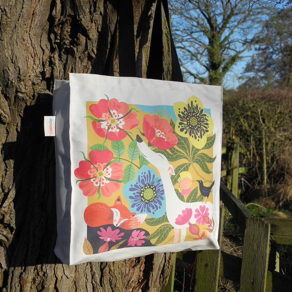 A Dog Rose tote bag by Rollerdog, showing it outside in the sunshine