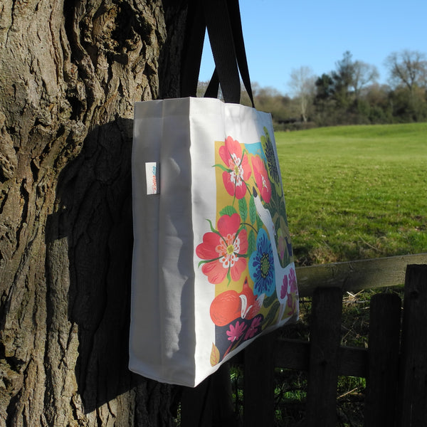 The side of a Dog Rose tote bag by Rollerdog, taken in the countryside 