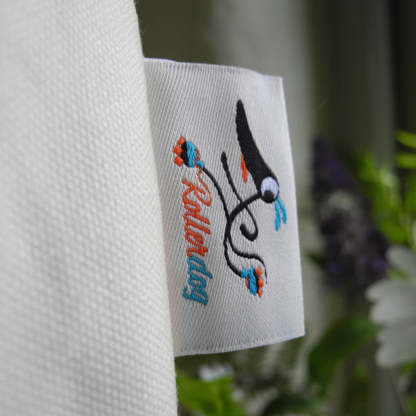 A close up view of an embroidered  Rollerdog label on a Freddie tote bag