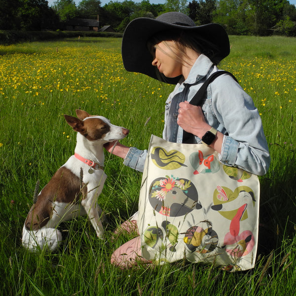 A Noses & Poses tote bag, shown in use as a shoulder bag