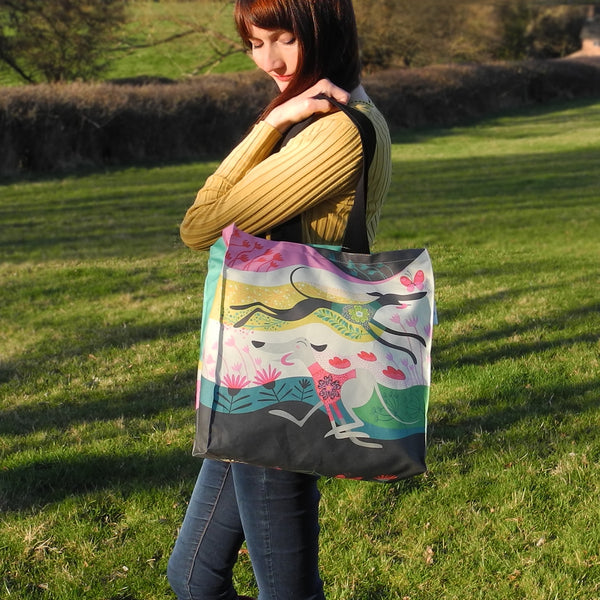 A Zoomies tote bag shown in use as a shoulder bag